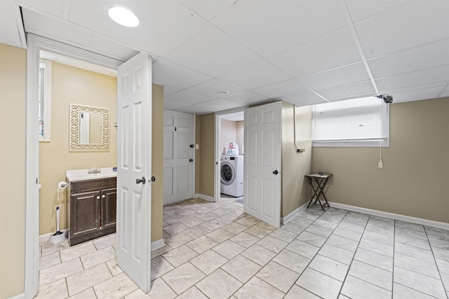  - laundry area featuring washer / clothes dryer and light tile patterned flooring