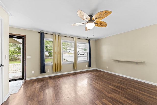  - unfurnished room featuring wood finished floors, plenty of natural light, ornamental molding, and a ceiling fan