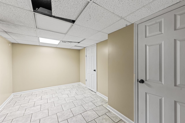  - finished below grade area with a paneled ceiling and baseboards