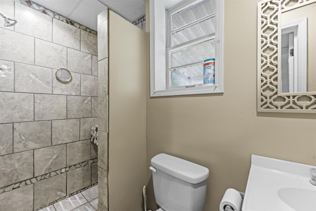  - full bath with tiled shower, vanity, and a drop ceiling