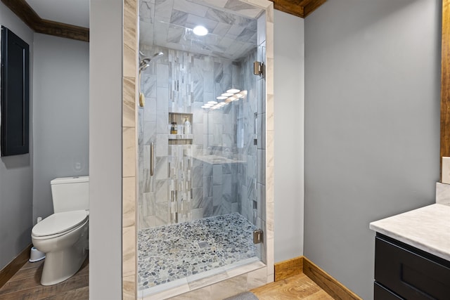 bathroom with vanity, toilet, baseboards, and a stall shower