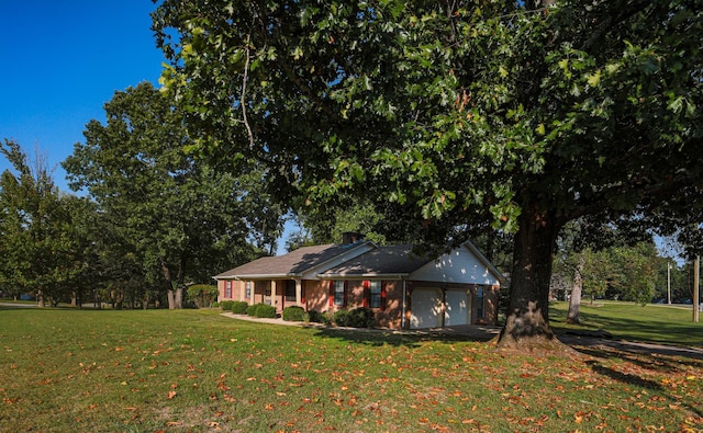 view of front of property with a front yard and a garage