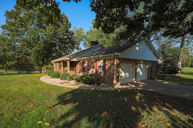 view of side of home with a yard and a garage