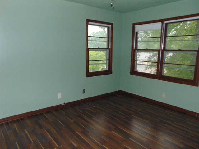 unfurnished room featuring dark hardwood / wood-style flooring