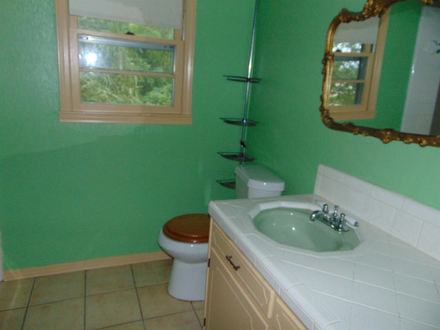 bathroom with tile patterned floors, vanity, and toilet