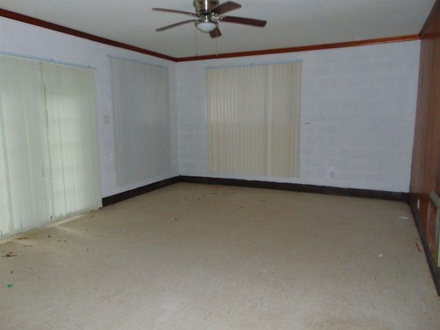 spare room with ceiling fan and crown molding