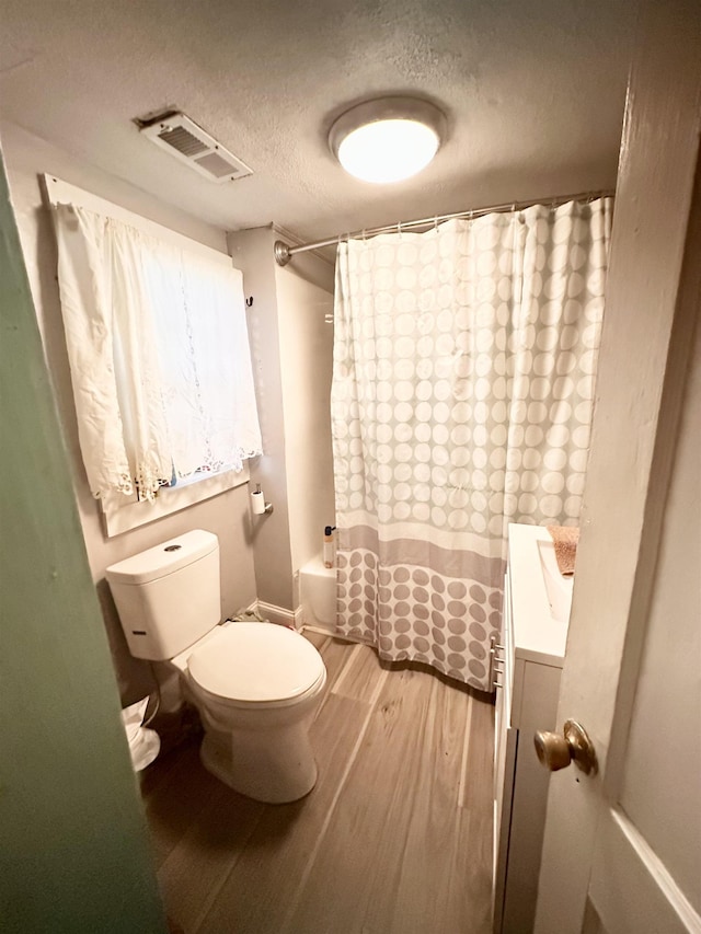  - full bath featuring wood finished floors, vanity, and a textured ceiling