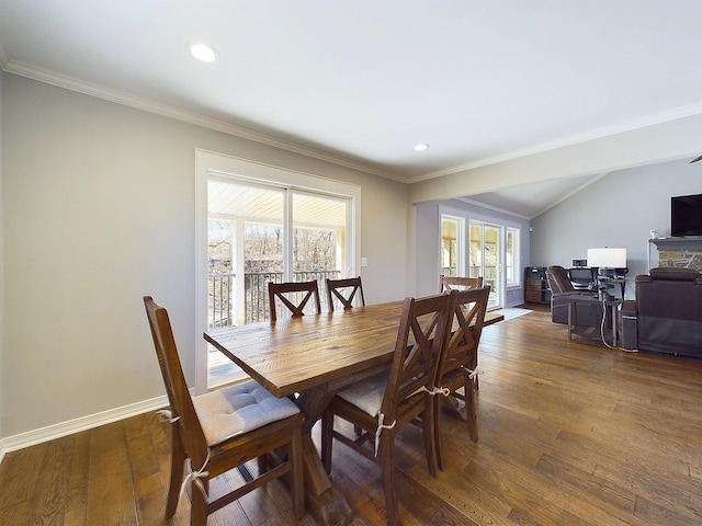 dining room with ornamental molding, hardwood / wood-style floors, and baseboards