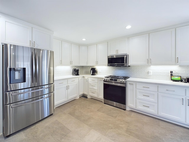 kitchen featuring recessed lighting, stainless steel appliances, white cabinetry, light countertops, and tasteful backsplash