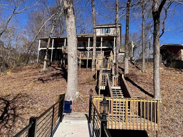 rear view of property with a deck and stairs