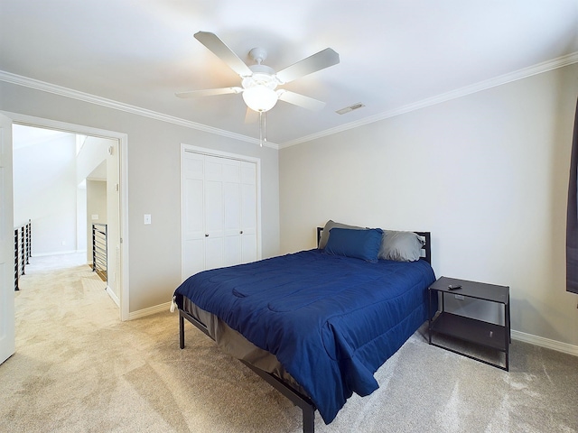 bedroom with light carpet, visible vents, baseboards, a closet, and crown molding