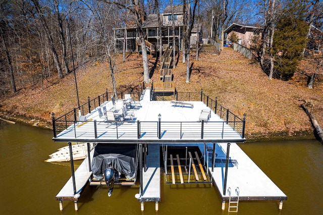 dock area featuring a water view, boat lift, and stairs