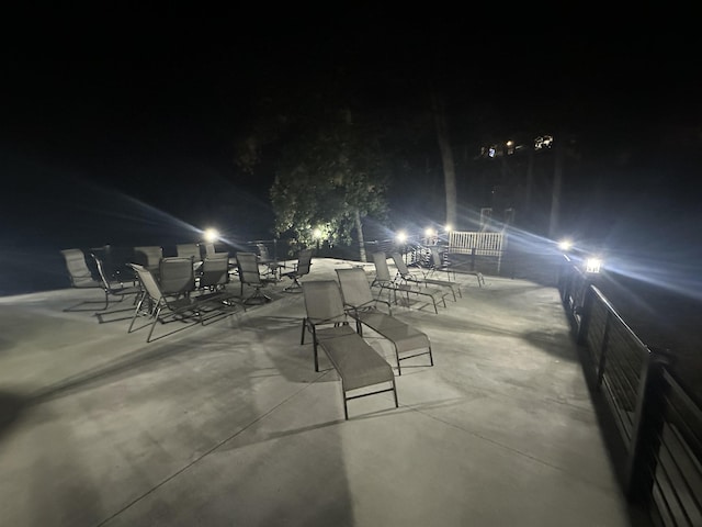 patio at night featuring outdoor dining space