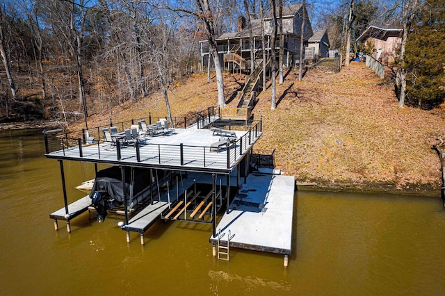 dock area with stairway, a water view, and boat lift