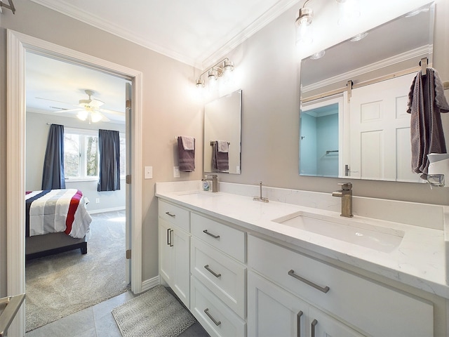 ensuite bathroom featuring ornamental molding, connected bathroom, a sink, and a ceiling fan