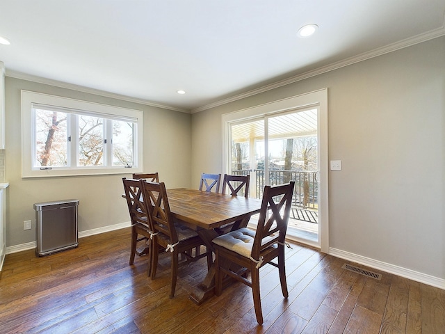 dining space featuring plenty of natural light, visible vents, and dark wood finished floors