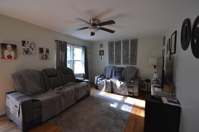 living room featuring ceiling fan and hardwood / wood-style flooring