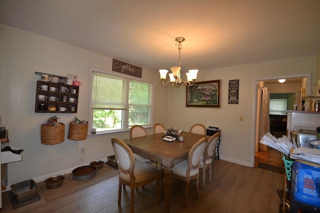 dining area featuring hardwood / wood-style flooring and a notable chandelier