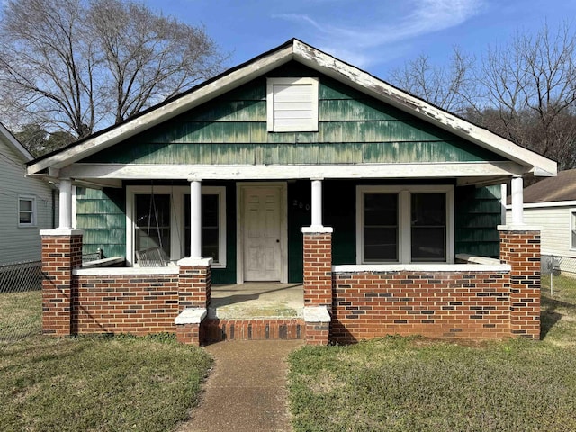 bungalow-style house with a front lawn