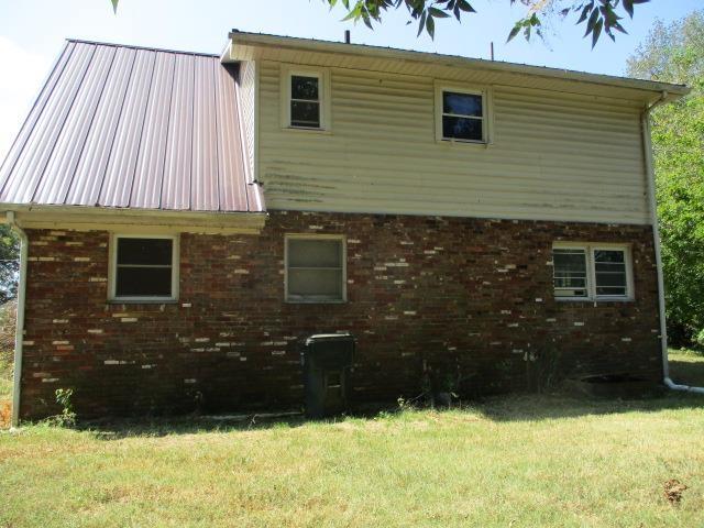 view of home's exterior with a lawn