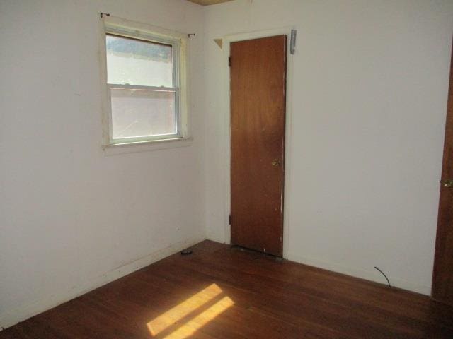 spare room featuring dark hardwood / wood-style floors