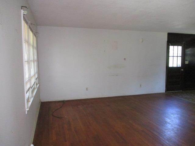 unfurnished room featuring dark wood-type flooring