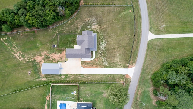 birds eye view of property with a rural view