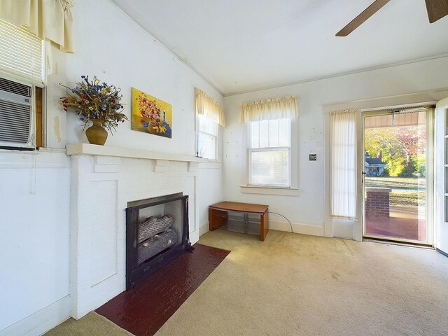 carpeted living room featuring ceiling fan and ornamental molding