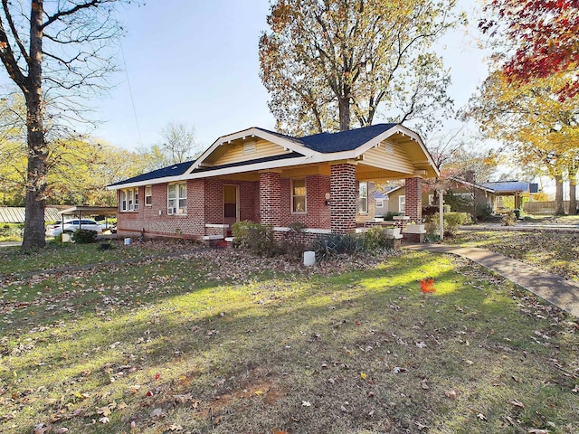 view of side of property featuring a lawn and covered porch