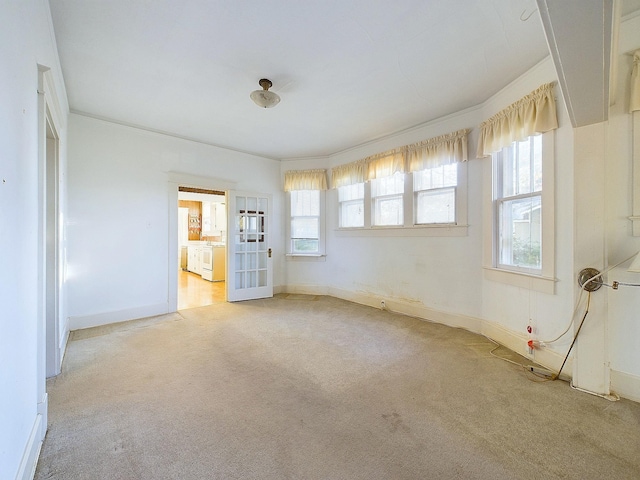 carpeted spare room with crown molding