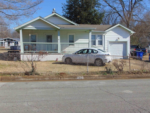 view of front of property with a front yard, a garage, and a porch