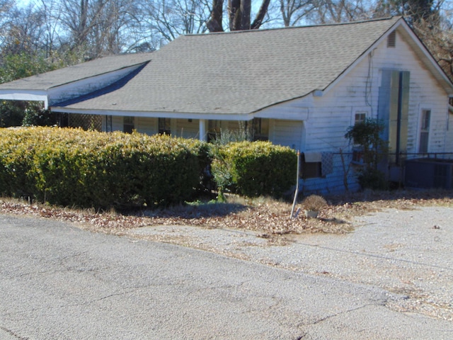 view of side of home with central AC