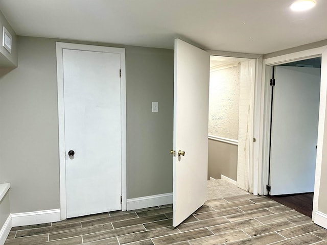  - unfurnished bedroom featuring wood finish floors and baseboards