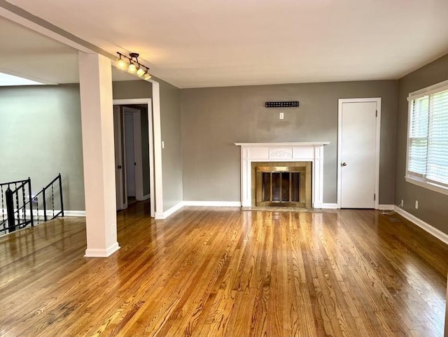  - unfurnished living room featuring wood finished floors and a fireplace