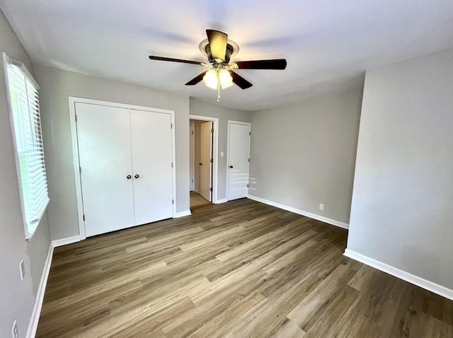  - unfurnished bedroom with wood finished floors, a closet, and ceiling fan