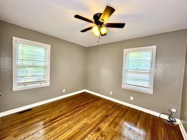  - unfurnished room featuring a ceiling fan and dark wood finished floors