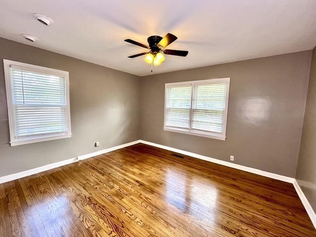  - unfurnished room featuring a ceiling fan and wood finished floors