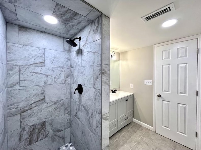  - bathroom with vanity and a tile shower