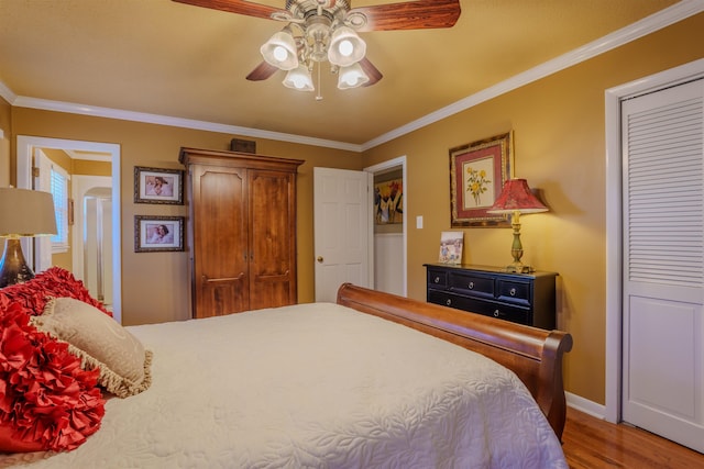 bedroom with ceiling fan, hardwood / wood-style flooring, and crown molding