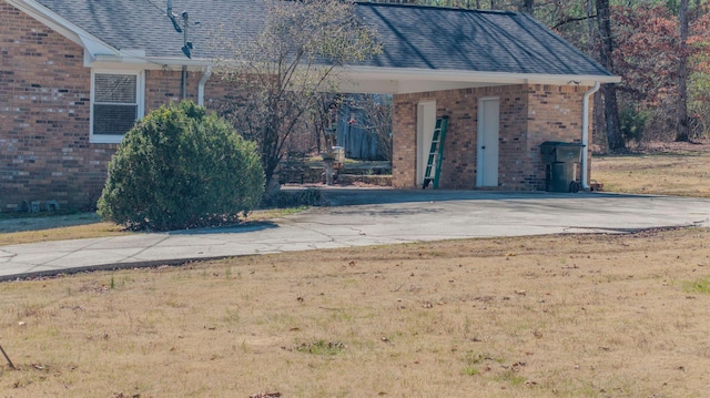 view of exterior entry featuring a lawn