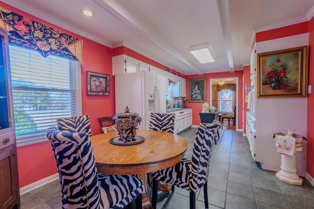 dining space with tile patterned floors and ornamental molding