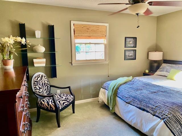 carpeted bedroom with ceiling fan