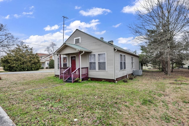 - bungalow-style house featuring central AC, a chimney, and a front yard