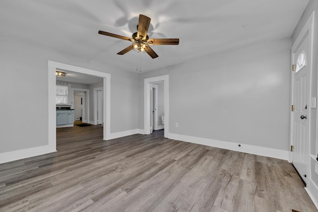  - interior space featuring baseboards, wood finished floors, and ceiling fan