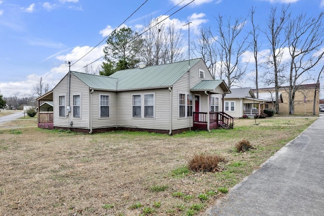  - view of front of home with a front lawn and metal roof