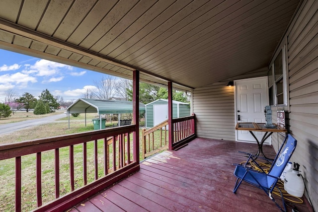 - wooden deck with a storage unit, a lawn, and an outbuilding