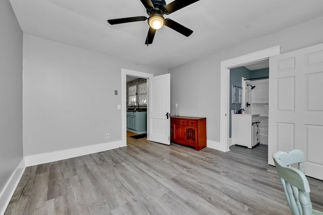  - unfurnished bedroom featuring baseboards, a ceiling fan, and light wood finished floors
