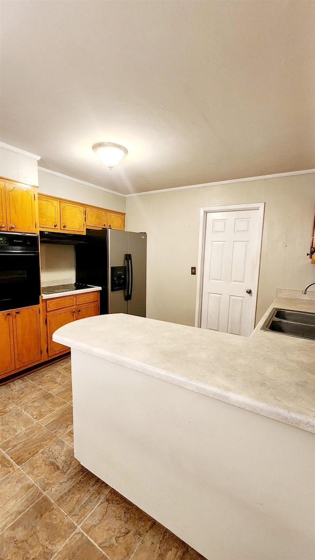 kitchen with stainless steel fridge, cooktop, oven, and sink