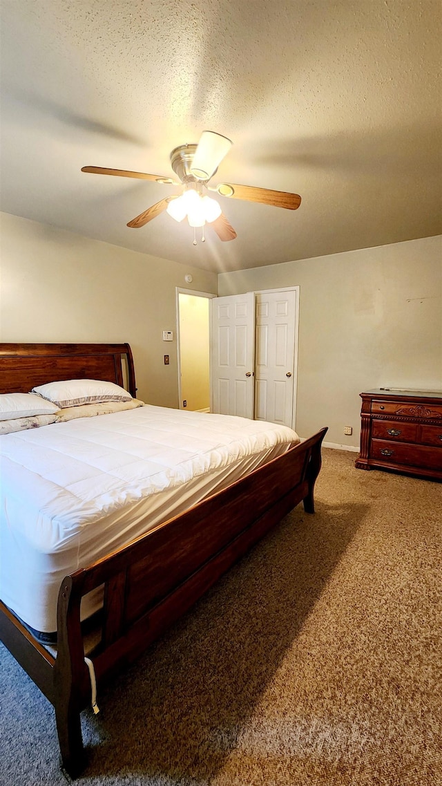 bedroom with carpet flooring, ceiling fan, and a textured ceiling