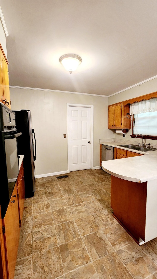 kitchen with kitchen peninsula, crown molding, sink, and appliances with stainless steel finishes